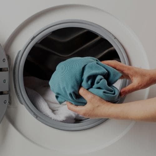 Self service laundry services photo showing customers' clothes being washed