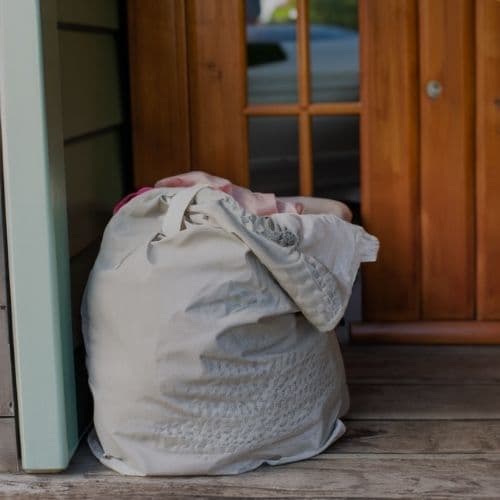 A laundry bag waiting on someone's doorstep