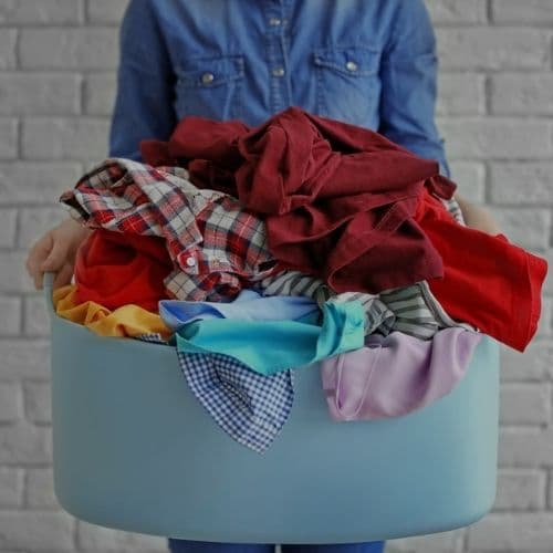 Image of someone holding a laundry bin