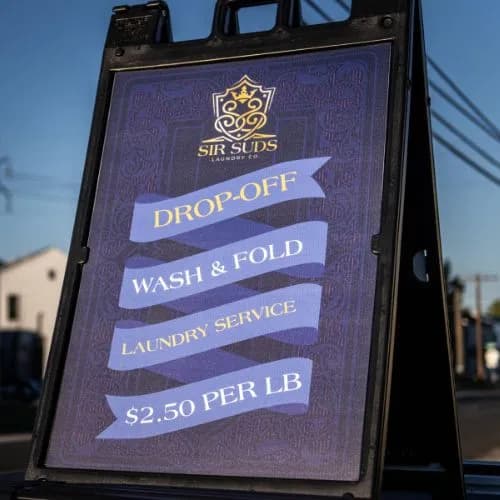 Photo of a sign advertising Sir Suds' drop off wash anf fold services